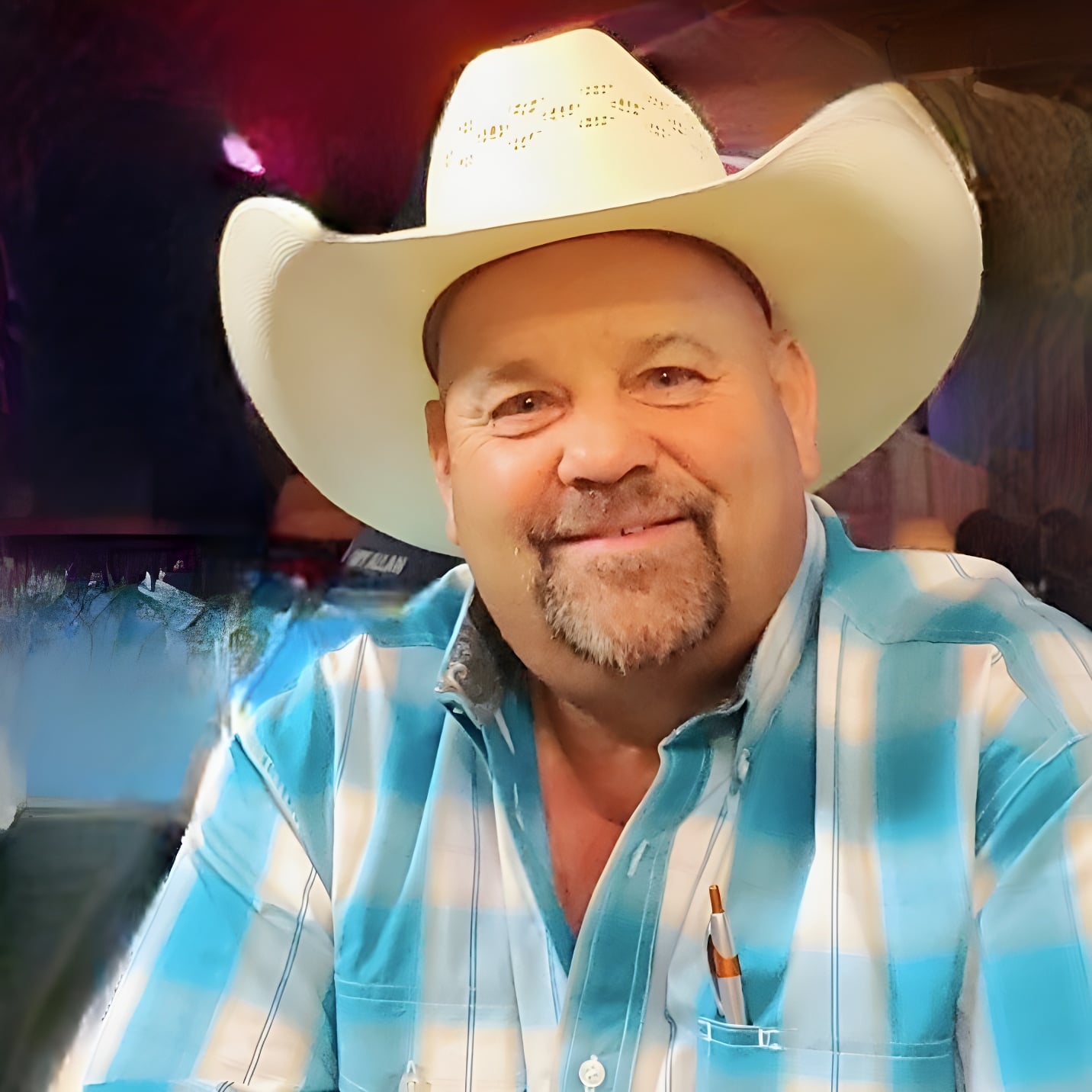 Shane Swett, Republican candidate for Wyoming State Representative District 13, wearing a white cowboy hat and teal plaid shirt, smiling
